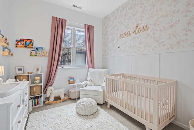 1942 W Armitage Ave Unit 2, Chicago, IL 60622 - bedroom featuring a nursery area, wallpapered walls, carpet, and wainscoting
