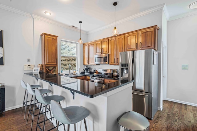 1942 W Armitage Ave Unit 2, Chicago, IL 60622 - kitchen featuring stainless steel appliances, a breakfast bar, brown cabinets, a peninsula, and dark wood-style flooring
