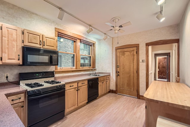 1331 W Greenleaf Ave Unit 2, Chicago, IL 60626 - kitchen with black appliances, rail lighting, a sink, ceiling fan, and light wood-style flooring