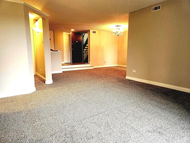 carpeted empty room with a chandelier, stairway, and baseboards
