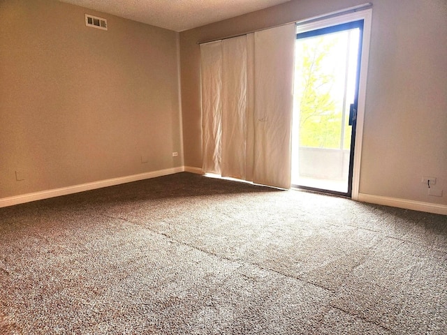 carpeted empty room featuring plenty of natural light and baseboards