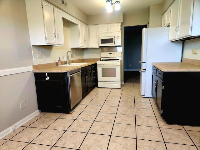 kitchen featuring white appliances, a sink, dark cabinetry, and white cabinetry