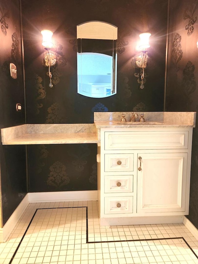 bathroom featuring wallpapered walls, baseboards, vanity, and tile patterned flooring