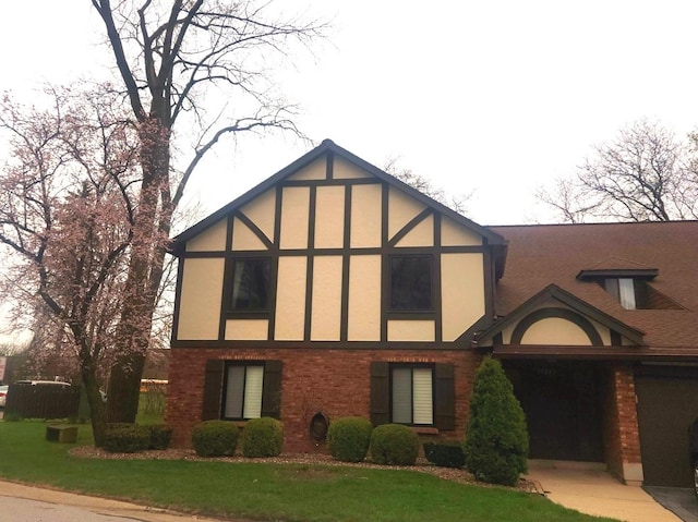 tudor house featuring stucco siding, brick siding, and a front yard