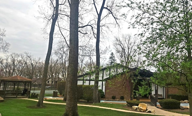 view of home's community featuring a gazebo and a lawn