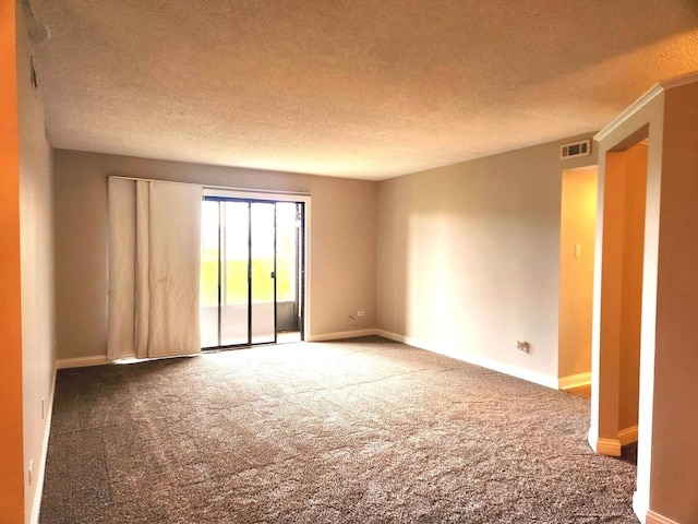 carpeted empty room with baseboards and a textured ceiling