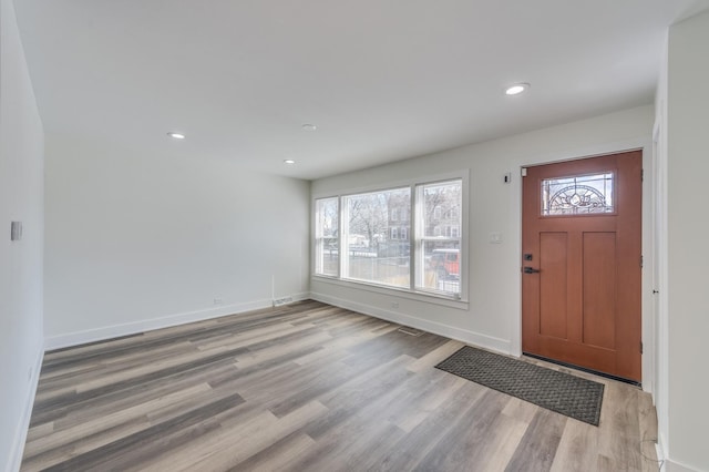 foyer featuring light wood-type flooring, baseboards, and recessed lighting