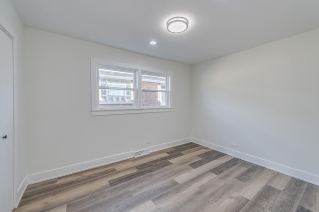 spare room featuring recessed lighting, baseboards, visible vents, and light wood-style flooring
