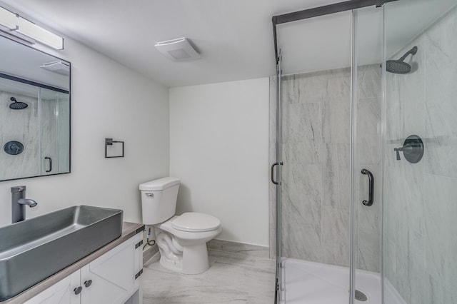 full bath featuring a shower stall, marble finish floor, toilet, and vanity