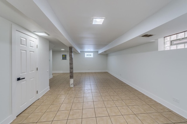 below grade area featuring visible vents, baseboards, and light tile patterned floors