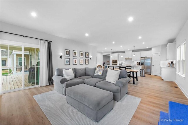 living area with recessed lighting and light wood-type flooring