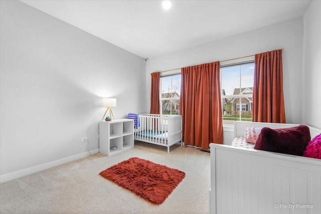 bedroom featuring baseboards and carpet