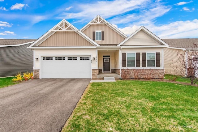 craftsman-style home featuring a front lawn, aphalt driveway, stone siding, board and batten siding, and a garage