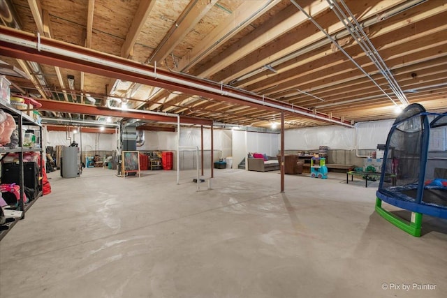 unfinished basement featuring heating unit and gas water heater