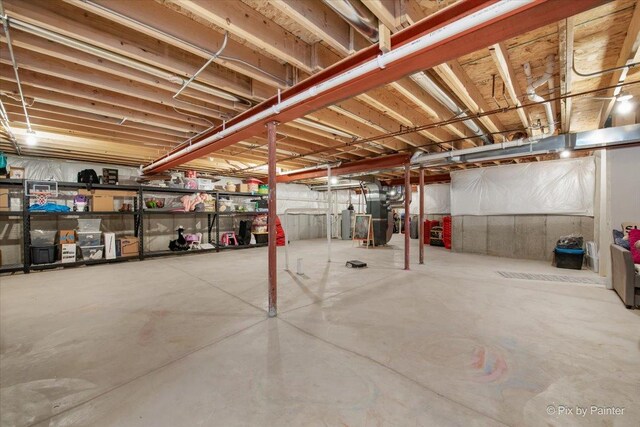 unfinished below grade area with water heater and heating unit