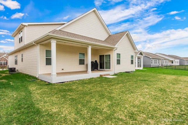 back of property featuring fence, a patio area, a yard, and central air condition unit