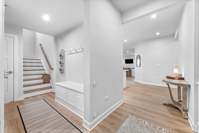interior space with recessed lighting, baseboards, light wood finished floors, and stairs