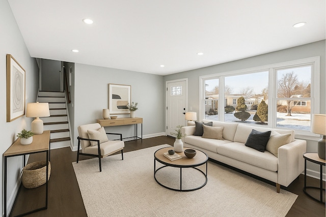 living room featuring wood finished floors, stairs, and recessed lighting