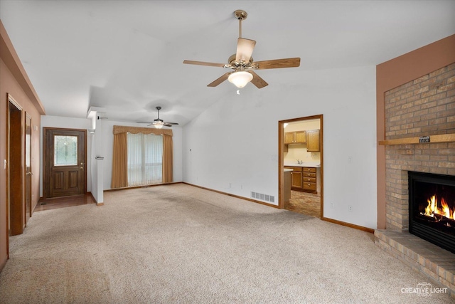 1231 Anthony Ln, Sandwich, IL 60548 - unfurnished living room featuring light carpet, a fireplace, ceiling fan, baseboards, and lofted ceiling