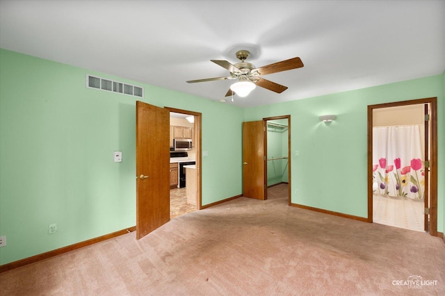 1231 Anthony Ln, Sandwich, IL 60548 - unfurnished bedroom featuring a walk in closet, light carpet, connected bathroom, and a closet