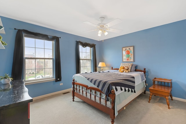 bedroom with carpet flooring, a ceiling fan, baseboards, and visible vents
