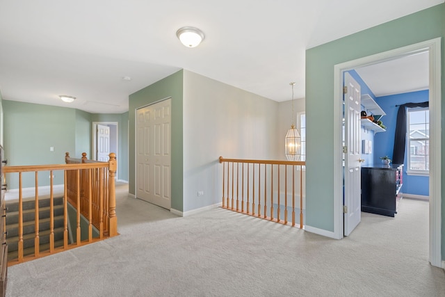 carpeted spare room featuring baseboards