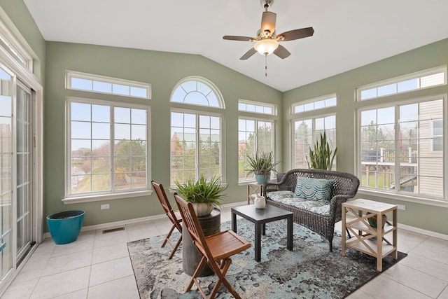 sunroom with baseboards, lofted ceiling, tile patterned floors, and visible vents