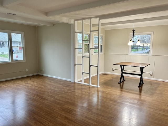 1407 Calhoun St, Peru, IL 61354 - unfurnished dining area with beamed ceiling, plenty of natural light, and wood finished floors