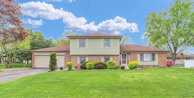 3104 Park Haven Blvd, Danville, IL 61832 - tri-level home featuring brick siding, a garage, driveway, and roof with shingles