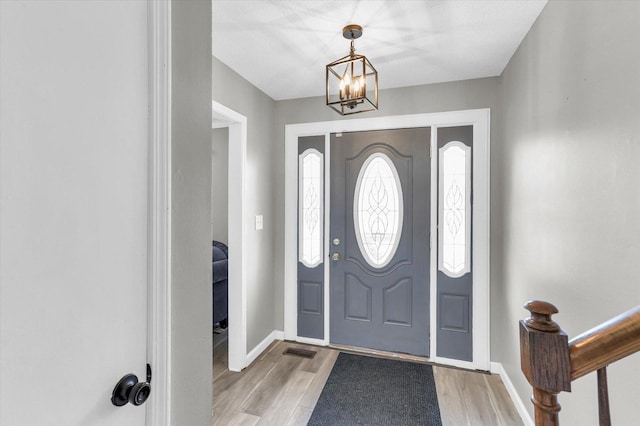 3104 Park Haven Blvd, Danville, IL 61832 - foyer entrance featuring light wood finished floors, baseboards, and a chandelier