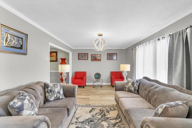 3104 Park Haven Blvd, Danville, IL 61832 - living room featuring a chandelier, ornamental molding, light wood-type flooring, a textured ceiling, and baseboards