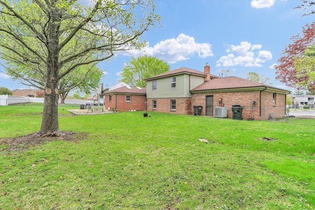 3104 Park Haven Blvd, Danville, IL 61832 - back of house with brick siding, central AC, and a chimney