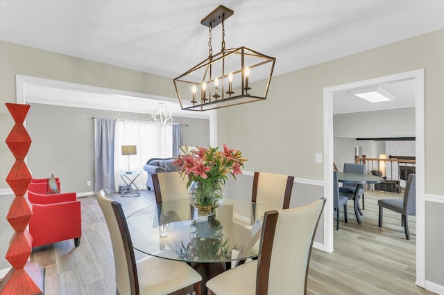 3104 Park Haven Blvd, Danville, IL 61832 - dining area featuring a chandelier, wood finished floors, and baseboards