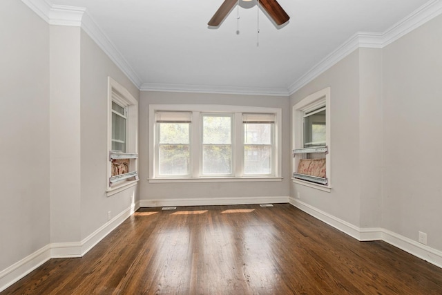 unfurnished room featuring crown molding, ceiling fan, baseboards, and dark wood-type flooring