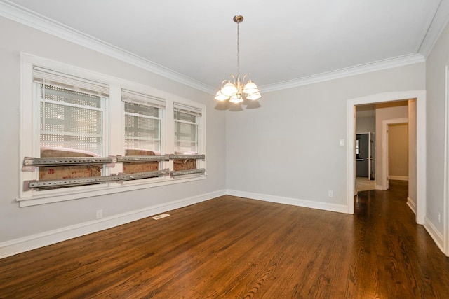 spare room with baseboards, wood finished floors, a notable chandelier, and crown molding