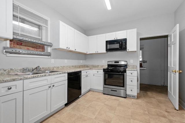 kitchen featuring black appliances, a sink, and white cabinets