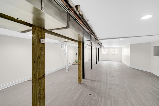 basement featuring wood finished floors and baseboards