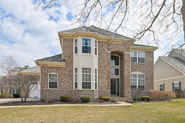 1037 Moray Dr, Inverness, IL 60010 - view of front of home with a front lawn, brick siding, and a garage