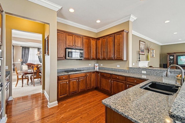 1037 Moray Dr, Inverness, IL 60010 - kitchen with stainless steel microwave, light wood finished floors, a sink, and gas stovetop
