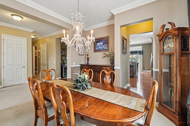 1037 Moray Dr, Inverness, IL 60010 - dining space featuring crown molding, baseboards, a notable chandelier, and light colored carpet