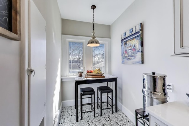 dining area featuring baseboards and light tile patterned flooring