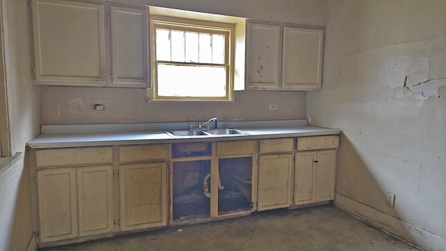 15231 Ashland Ave, Harvey, IL 60426 - kitchen with concrete flooring, light countertops, decorative backsplash, and a sink