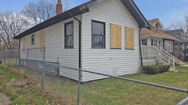 15231 Ashland Ave, Harvey, IL 60426 - view of home's exterior featuring a chimney, fence, and a lawn