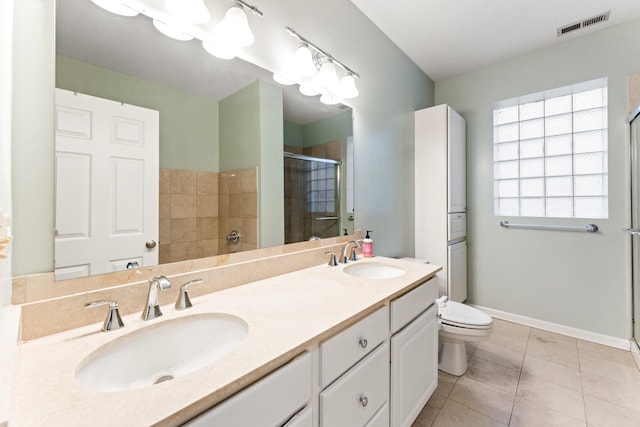 bathroom featuring visible vents, a sink, toilet, and a shower stall