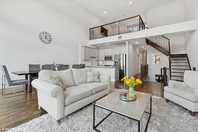 29 N Morgan St Unit Ph, Chicago, IL 60607 - living area featuring stairs, dark wood-type flooring, a high ceiling, and recessed lighting
