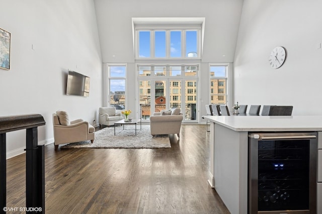29 N Morgan St Unit Ph, Chicago, IL 60607 - living area featuring wine cooler, dark wood-style flooring, a high ceiling, and baseboards
