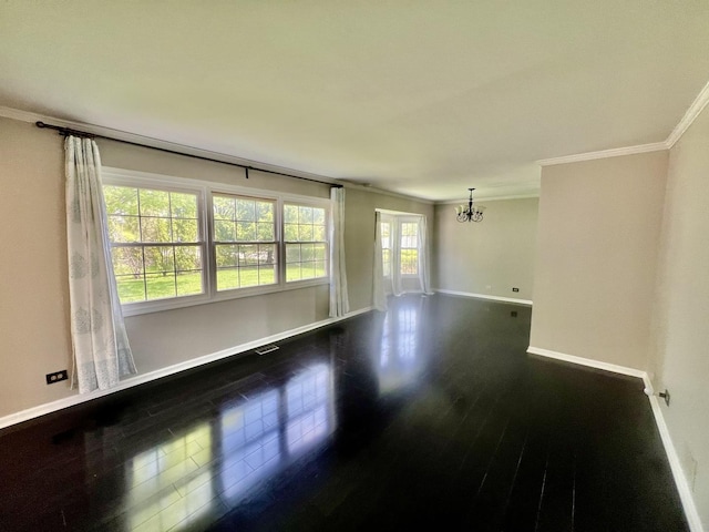 unfurnished room featuring ornamental molding, a chandelier, baseboards, and dark wood-style floors