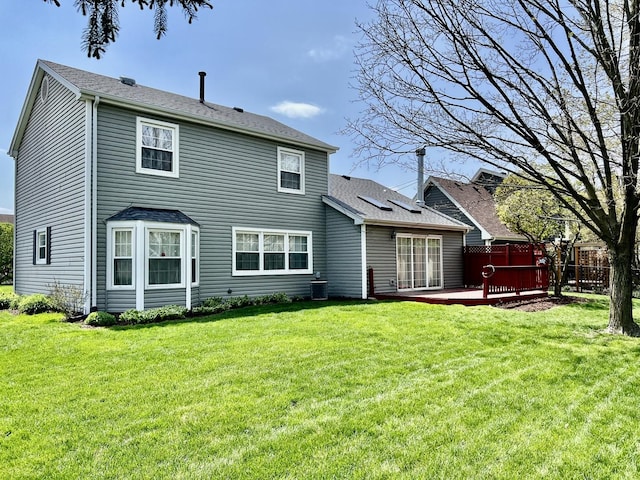 rear view of property featuring a wooden deck, central AC, and roof with shingles