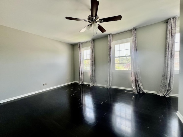 unfurnished room with baseboards, a ceiling fan, and wood finished floors