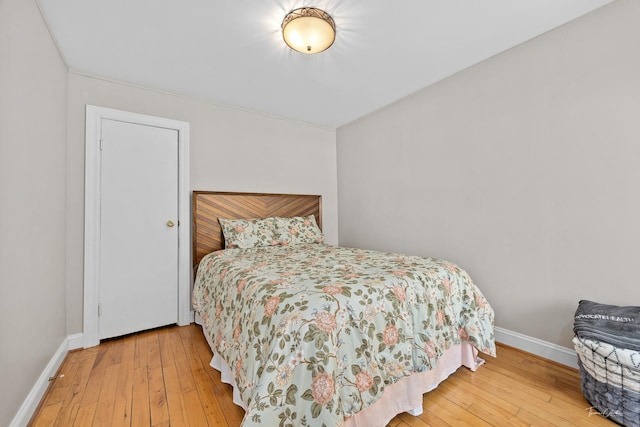 bedroom featuring wood-type flooring and baseboards
